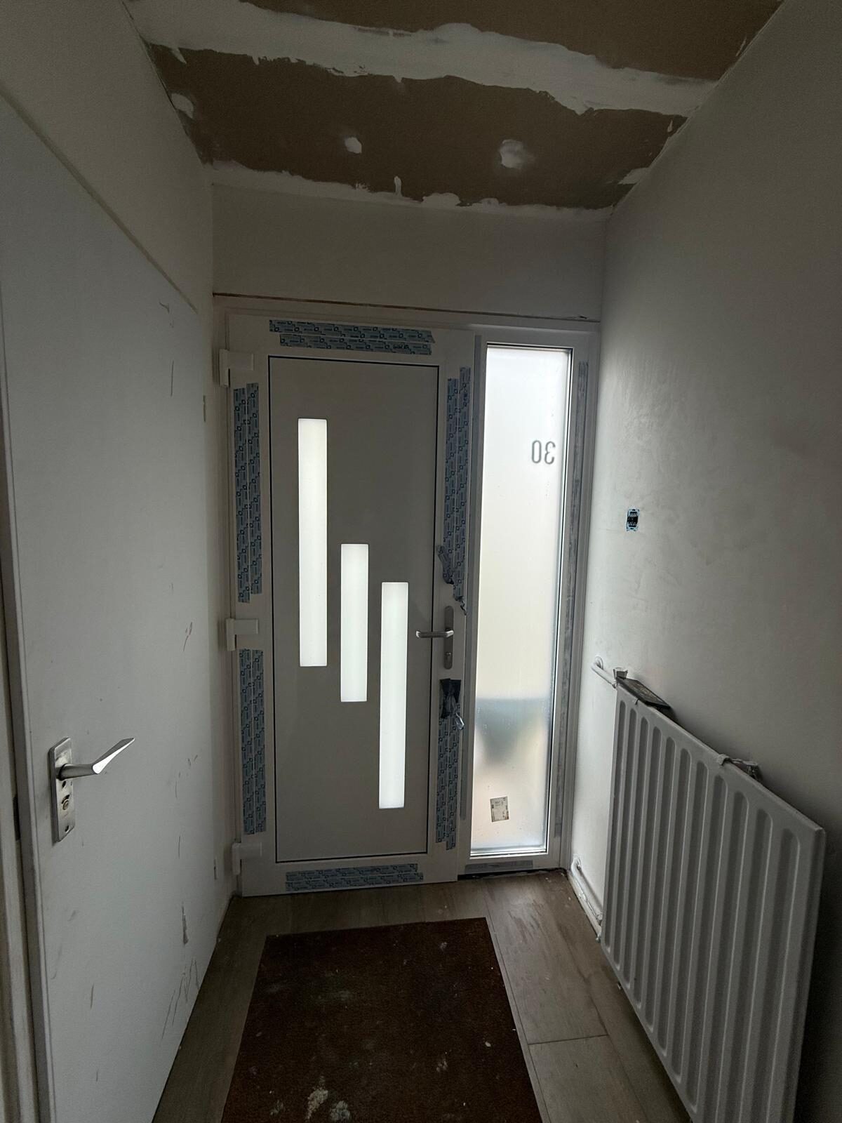 Hallway with a new front door and plastering in Nieuwegein area, photo 1 of 2